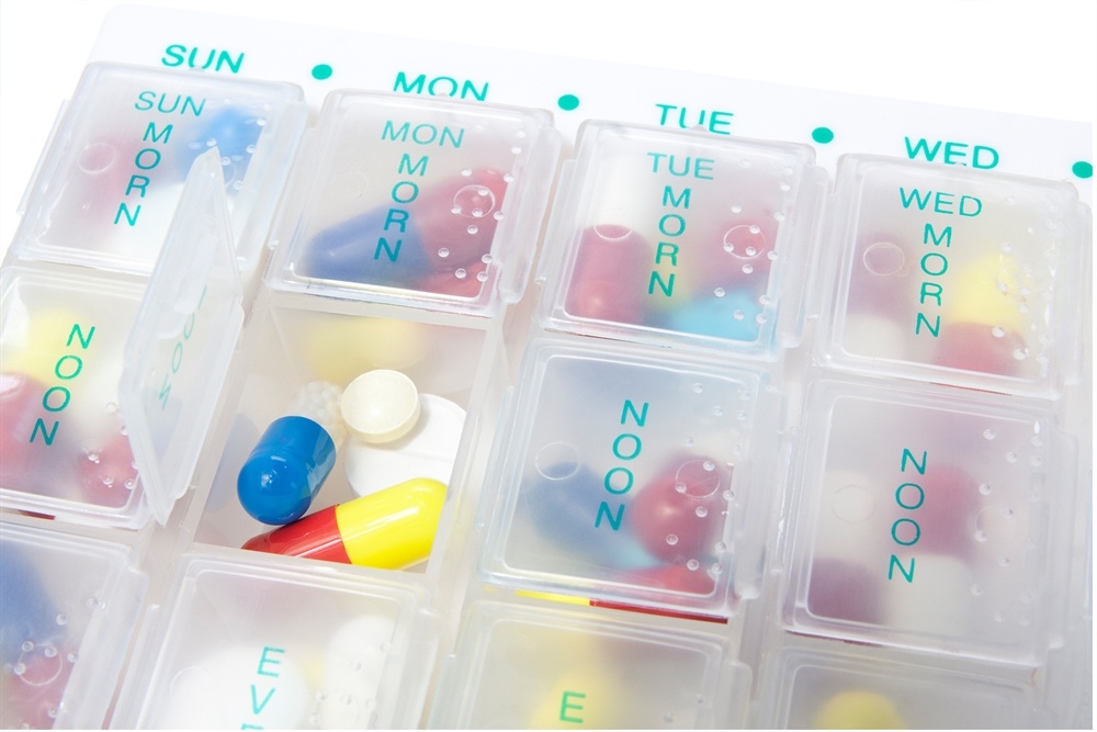 Medication review, featuring a complex display of pills in a medication organizer